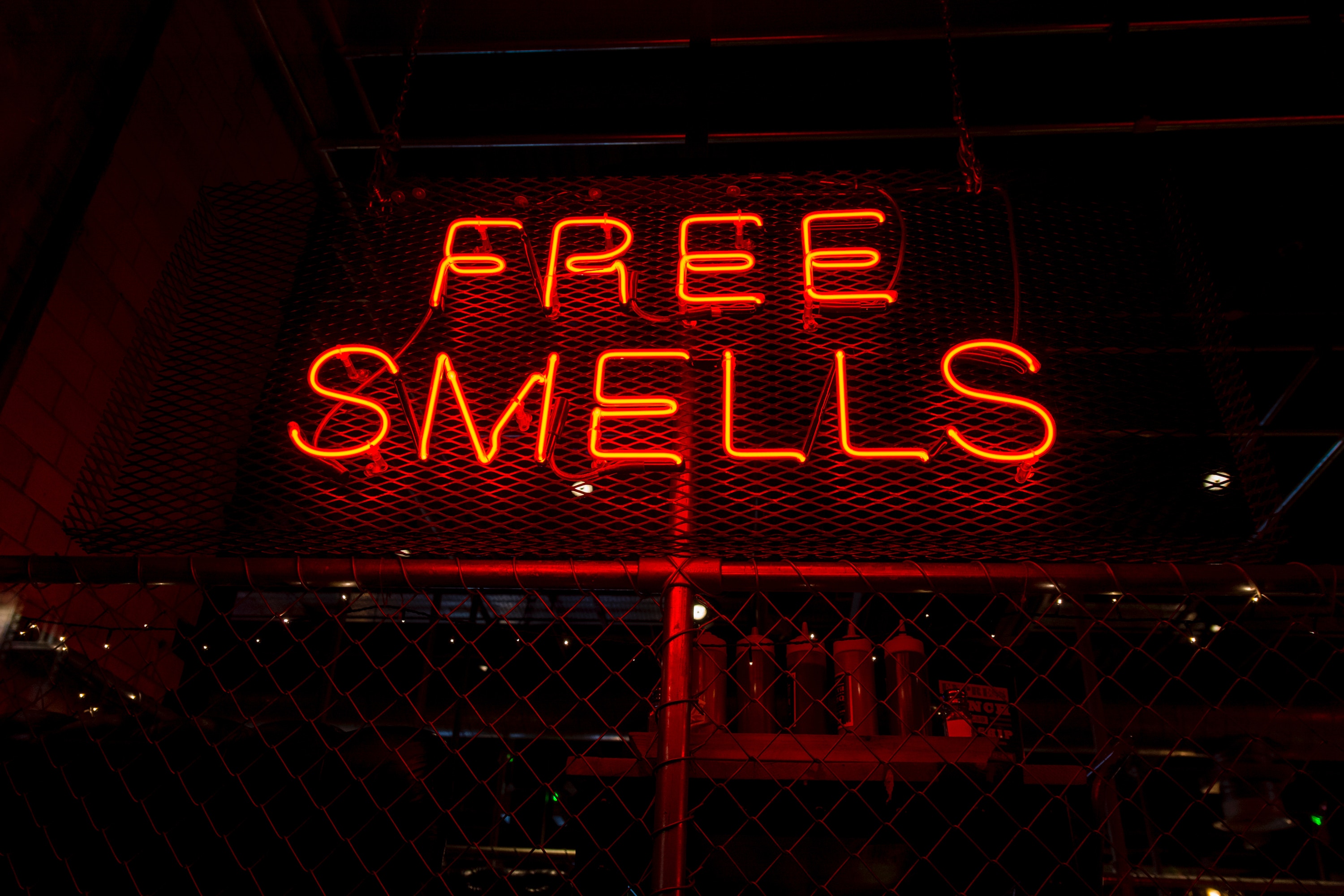 neon sign that says free smells